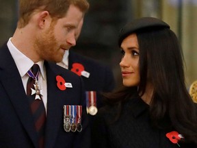 Britain's Prince Harry (L) and his US fiancee Meghan Markle attend a service of commemoration and thanksgiving to mark Anzac Day in Westminster Abbey in London on April 25, 2018. Anzac Day marks the anniversary of the first major military action fought by Australian and New Zealand forces during the First World War.