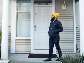 NDP Leader Jagmeet Singh waits to see if someone will answer while door-knocking for his byelection campaign in Burnaby, B.C.