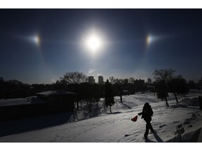 Sun Dogs, formed by the sun reflecting off ice crystals in bitterly cold temperatures, sit over the Winnipeg skyline Wednesday, Jan. 30, 2019. Winnipeg and the region has been experiencing below -35 degree celsius temperatures and windchills of -45 to -50 degree celsius.