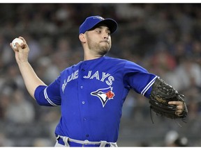 FILE - In this Sept. 14, 2018, file photo, Toronto Blue Jays pitcher Marco Estrada delivers to a New York Yankees batter during the first inning of a baseball game at Yankee Stadium in New York. Estrada agreed to a $4 million, one-year contract Friday, Jan. 25, with the Oakland Athletics, giving the club a veteran presence in a rotation that was plagued by injuries last season.