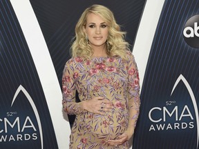 FILE - In this Nov. 14, 2018 file photo, Carrie Underwood arrives at the 52nd annual CMA Awards in Nashville, Tenn. Underwood and husband Mike Fisher announced the birth of their second son, Jacob Bryan Fisher, in a post on Instagram. The 35-year-old singer posted photos of the newborn, who she said was born early Monday, Jan. 21.