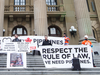 Supporters stand on the steps of the Alberta legislature during a pro-pipeline rally in Edmonton.