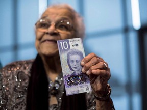 Wanda Robson, sister of Viola Desmond, holds the new $10 bank note featuring Desmond during a press conference in Halifax on Thursday, March 8, 2018.
