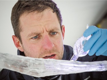 Samuel Girault, a member of the France and Poland ice carving team works on the final touches of the sculpture during Winterlude, Sunday Feb. 3, 2019.