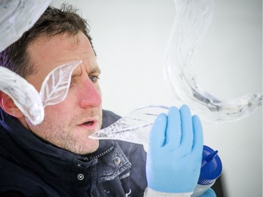 Samuel Girault, a member of the France and Poland ice carving team works on the final touches of the sculpture during Winterlude, Sunday Feb. 3, 2019.   Ashley Fraser/Postmedia