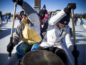 The Ottawa Ice Dragon Boat Festival took place Saturday on Dow's Lake. Diana Babor, left, and Kate Ryan help propel their boat in one of the many races.
