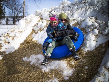People enjoyed the sunshine in the Snowflake Kingdom in Jacques-Cartier Park Sunday Feb. 10, 2019 part of the Winterlude festivities. Kim and two-year-old Rowan Mackrael went up the break wall of the super slide Sunday.