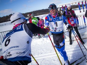 Andy Shields the winner of the 51km race celebrates with third place finisher Olivier Hamel during the Gatineau Loppet, Saturday Feb. 16, 2019.