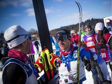 Andy Shields the winner of the 51km race celebrates with third place finisher Olivier Hamel during the Gatineau Loppet, Saturday Feb. 16, 2019.