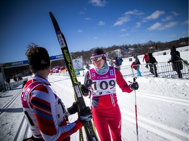First place female in the 51km race Megan McTavish talks to second place Sara Graves at the finish line during the Gatineau Loppet, Saturday Feb. 16, 2019.