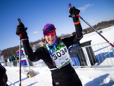 Joann Hanowski celebrates being the first female to finish the 27km race during the Gatineau Loppet, Saturday Feb. 16, 2019.