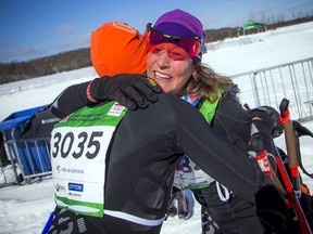 JoAnn Hanowski celebrates with her husband after finishing first in the women's division in the 27K Classic race during the Gatineau Loppet on Saturday, Feb. 16, 2019.