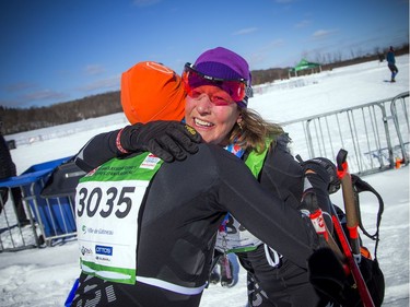 Joann Hanowski celebrates with her husband after finishing as the first female in the 27km race during the Gatineau Loppet, Saturday Feb. 16, 2019.