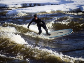 Tristan Lafontaine surfing on the Ottawa River Saturday Feb. 16, 2019.