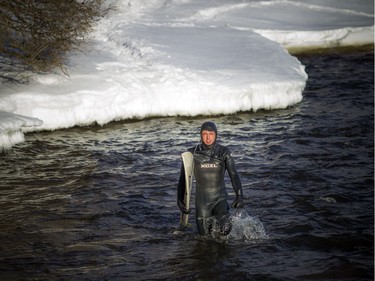 Pierre-Karl Sanscartier gets out of the Ottawa River after a surf session on Saturday.