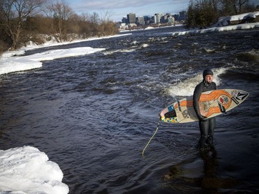Pierre-Karl Sanscartier gets ready to surf on the Ottawa River on Saturday.