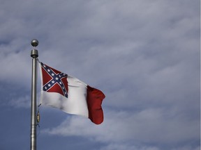 RICHMOND, VA - FEBRUARY 08: A flag of the Confederate States of America (this version also known as the third national flag of the Confederacy and "The Blood-Stained Banner) flies near the gravesite of Jefferson Davis, former president of the Confederate States of America, at Hollywood Cemetery, February 8, 2019 in Richmond, Virginia. Virginia state politics are in a state of upheaval, with Governor Ralph Northam, State Attorney General Mark Herring, both Democrats, and Republican Senate Majority Leader Tommy Norment involved with past uses associations with blackface and Lt. Governor Justin Fairfax, a Democrat, accused of sexual misconduct by two women.