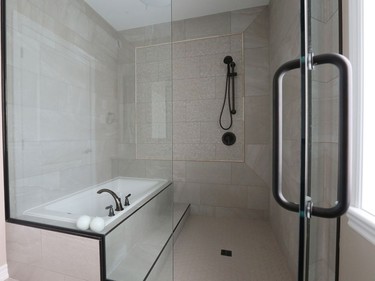 The bathroom in the bungalow has been imagined for someone with mobility issues. The shower has a barrier-free entry and the tub has an extra step for easy access. The modified 'shower room' is one of only three upgrades in the bungalow.