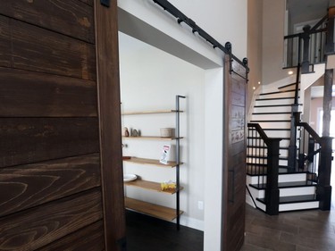 Barn doors on the office and an upgraded staircase greet you in the soaring two-storey foyer of the main home.