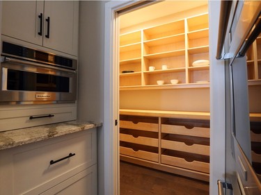 An oversized pantry, fully outfitted with cabinets and shelves, and an adjacent butler’s station help keep things tidy yet handy when entertaining.