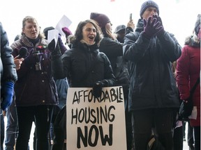 Tammy Corner (holding sign) took part in a rally for affordable housing outside of Ottawa City Hall before City Council met to discuss the budget on Feb. 6.  (Errol McGihon/Postmedia)