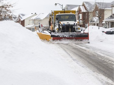 A snowplow clears Beatrice Drive following a winter storm in Ottawa on February 13, 2019.