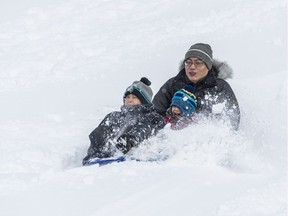 Nick Wang enjoys a toboggan run with his children Renny, 8 years, and Robin, 2.5 years, at Walter Baker Park in Kanata on February 13, 2019.