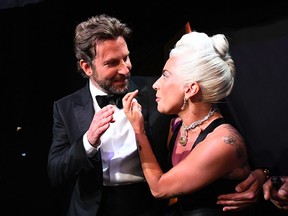 This handout photo released by A.M.P.A.S. shows US singer Lady Gaga talking to US actor Bradley Cooper backstage during the 91st Annual Academy Awards at the Dolby Theatre in Hollywood, California on February 24, 2019.
