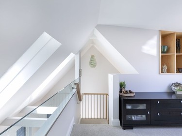 A new staircase leading to the loft was added during the renovation. It is used an office space and had lots of natural light coming through the windows nearby.