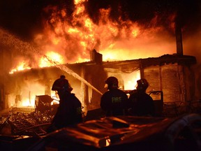 In this Wednesday, Feb. 20, 2019, photo, firefighters try to douse a fire in Dhaka, Bangladesh. (AP Photo)