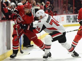 Aenators defenceman Mark Borowiecki (74) sends Hurricanes forward Nino Niederreiter into the boards during the first period of Tuesday's game at Canadian Tire Centre.