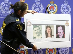 OPP Sgt. Cynthia Savard sets up photos of the three people police say were murdered by a man arrested by police Thursday in Kingston, Ont. on Friday, Feb. 15, 2019. Elliot Ferguson/The Whig-Standard/Postmedia Network