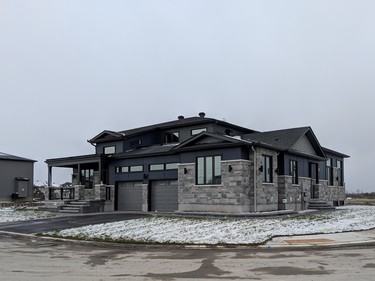 The model home at Trail View has the appearance of a large single home, but is actually a two-storey single-family home and a bungalow that are connected on the inside. Like all Metric homes, there is no vinyl siding. Exteriors are a mix of brick and Hardie board.