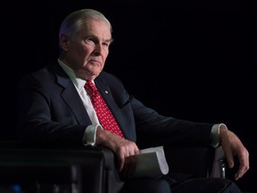 Michael Wilson, former federal minister of finance, sits on stage during the launch of the alternative stock exchange Aequitas NEO Exchange in Toronto on March 27, 2015. Michael Wilson, a former politician, diplomat and longtime mental health advocate, has died at 81.