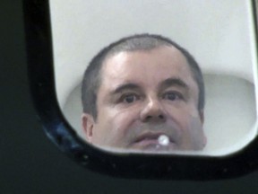 In this undated photo provided by the United States Drug Enforcement Administration, Mexican drug kingpin Joaquin "El Chapo" Guzman looks out the window of an airplane. Guzman, was convicted Tuesday, Feb. 12, 2019, of running an industrial-scale smuggling operation after a three-month trial packed with Hollywood-style tales of grisly killings, political payoffs, cocaine hidden in jalapeno cans, jewel-encrusted guns and a naked escape with his mistress through a tunnel. (United States Drug Enforcement Administration via AP)