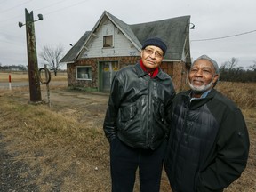 FILE - In this Dec. 3, 2018, file photo, Rev. Allen Threatt III, left, and his cousin Edward Threatt stand outside the historic Threatt Filling Station on U.S. 66 in Luther, Okla. The early gas station on Route 66 was a safe haven for African American travelers and locals.