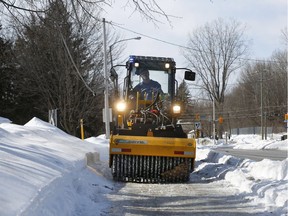 Road crews test drive a new 'ice breaker' for sidewalks. The 1,000-kg rollers punch small holes in packed ice packs, allowing salt to penetrate more deeply to allow scrapers to quickly remove ice. Tony Caldwell