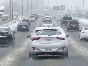 Traffic on Queensway during snow storm.