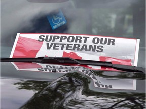 A sign is placed on a truck windshield as members of the advocacy group Banished Veterans protest outside the Veterans Affairs office in Halifax on Thursday, June 16, 2016. While most disabled veterans will see a small boost in financial support when the Trudeau government implements a new pension system in April, a new analysis shows some of the most severely injured will end up with less than under the current system.