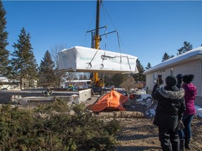 Spectators watch as two modules built by Guildcrest Homes were lifted by a 90 ton crane and set down on a basement foundation in under 3 hours. Aside from being rapidly installed which is great for infill lots as it minimizes the disturbance in the neighborhood; modular homes offer the advantage of having been built in a factory environment protected from the outside cold, snow and/or wet rain.