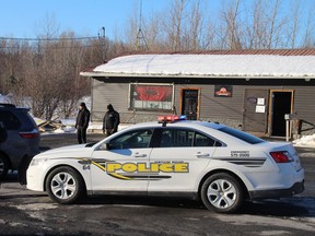Members of the Akwesasne Mohawk Police Service raid the Wild Flower Cannabis Dispensary on Tuesday Feb. 5, 2019 in Akwesasne, Ont.