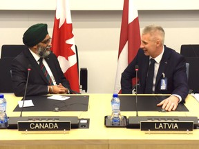 Minister of National Defence Harjit Sajjan meets with Latvia's Deputy Prime Minister, Minister of Defence Artis Pabriks at the NATO Defence Ministers’ Meeting in Brussels on February 13.