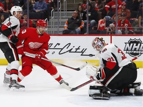 Ottawa Senators goaltender Anders Nilsson stops a shot from the Detroit Red Wings' Darren Helm in the second period on Thursday, Feb. 14, 2019, in Detroit.