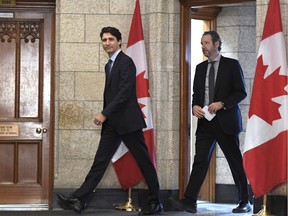 Prime Minister Justin Trudeau leaves his office with his principal secretary Gerald Butts to attend an emergency cabinet meeting on Parliament Hill in Ottawa on Tuesday, April 10, 2018. Butts has resigned amid allegations that the Prime Minister's Office interfered to prevent criminal prosecution of SNC-Lavalin.