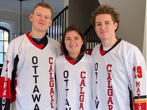 Brady, Taryn and Matthew Tkachuk model the jerseys that will be worn by almost 40 family members and friends Sunday in Ottawa when the brothers meet in an NHL game for the first time.