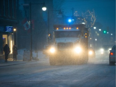 A salt truck heads up Bank Street as the city begins to experience the major winter storm on Tuesday.