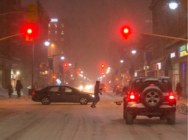 Pedestrians cross Bank Street at Gilmour 
late Tuesday afternoon.