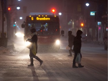 Pedestrians cross the intersection of Bank and Gilmour Streets in Centretown on Tuesday.