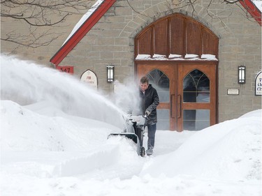 Paul Dumais clears snow to the church on Richmond Rd as the city crawls out from under a major winter storm which is possibly the biggest of the season.