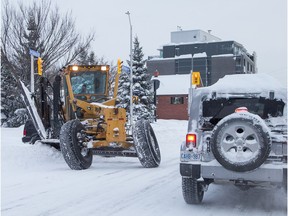 A plow makes a turn onto Richmond Road as the city crawls out from under a major winter storm which is possibly the biggest of the season.